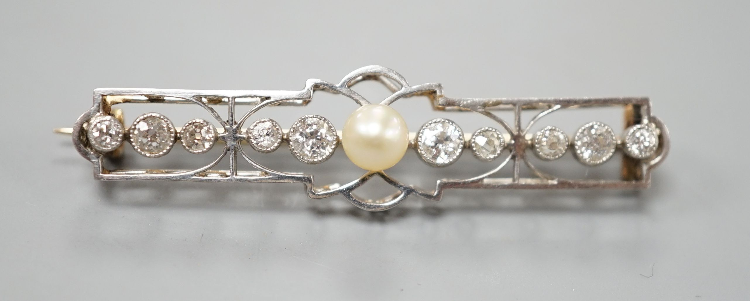 An early 20th century, yellow and white meta, cultured pearl and diamond set open work bar brooch, 41mm, gross weight 3.6 grams.